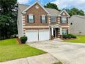 Charming two-story brick home with well-manicured lawn and a two-car garage at 5848 Rex Ridge Loop, Rex, GA 30273