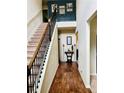 Inviting foyer with hardwood floors, staircase, and decorative accents creating a warm welcome at 5848 Rex Ridge Loop, Rex, GA 30273