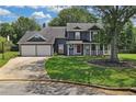 Charming two-story home with a well-manicured lawn, a two-car garage, and a welcoming front porch at 2505 Se Tiffany Ct, Conyers, GA 30013
