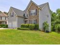 Well-maintained home with a lush lawn, tidy shrubbery, and neutral colored siding with black shutters at 347 Cobblestone Court, Hampton, GA 30228