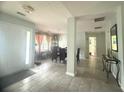 Inviting foyer with tile flooring leading to a dining area with natural light at 3484 Lynley Mill Ln, Dacula, GA 30019