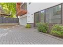 Attached garage and brick-paved driveway, complemented by manicured landscaping and a private balcony above at 367 Parkway Ne Dr # 9, Atlanta, GA 30312