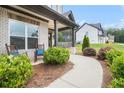 Inviting front porch with rocking chairs and landscaped walkway, showcasing a charming and welcoming entrance at 1660 Chandler Rd, Lawrenceville, GA 30045