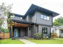Contemporary home with a wood-accented porch, minimalist landscaping, and a blue front door at 206 Mead Rd, Decatur, GA 30030