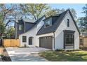 Charming home features a gray garage door, manicured lawn, and classic architectural details at 206 Mead Rd, Decatur, GA 30030