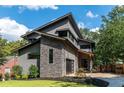 Modern home with stone accents, a sleek garage door, and a well-maintained lawn at 206 Mead Rd, Decatur, GA 30030