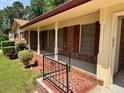 Inviting front porch with brick accents and decorative wrought iron railing at 3190 Cheru Ct, Decatur, GA 30034
