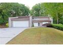 Charming exterior view of a two-story home with a well-kept lawn and convenient two-car garage at 6010 Spalding Dr, Atlanta, GA 30350