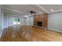 Spacious living room with hardwood floors, brick fireplace, recessed lighting, and natural light at 6010 Spalding Dr, Atlanta, GA 30350