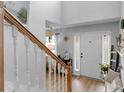 Bright entryway featuring a staircase and stylish decor with a wood-look floor and natural lighting at 710 Freeman Dr, Covington, GA 30016