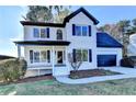 Charming two-story home with white brick, black shutters, an attached garage and a landscaped front yard at 1285 Cedar Brook Dr, Lawrenceville, GA 30043