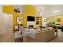 Cozy living room with fireplace, bright yellow walls, built-in shelving and comfortable seating at 1290 Silverstone Trl, Jonesboro, GA 30238