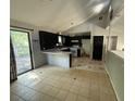 Open kitchen and dining area featuring a breakfast bar, tile floors, and access to an outdoor deck at 2715 Cordite Loop, Snellville, GA 30039