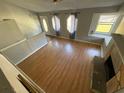 Open-concept living room featuring a cozy fireplace, large windows and entry door providing plenty of natural light at 2715 Cordite Loop, Snellville, GA 30039