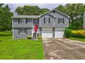 Charming two-story home with a red front door, a two-car garage, and green lawn at 4090 Mark Todd Ct, Hoschton, GA 30548