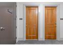 Hallway view of condo unit 1803 with wooden door and telephone sign at 3040 Peachtree Nw Rd # 1803, Atlanta, GA 30305