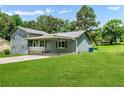 Home showcasing a covered carport with a well-maintained lawn on a sunny day at 320 Edna Dr, Stockbridge, GA 30281
