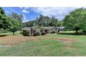 Sprawling single-story home with mature trees in a serene, green setting at 3467 Clubland Dr, Marietta, GA 30068