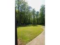 Expansive backyard with lush lawn surrounded by mature trees for ultimate privacy at 1010 Forest Overlook Sw Dr, Atlanta, GA 30331