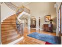 Elegant foyer with a curved staircase, hardwood floors, and soaring ceilings creating a grand entrance at 179 Worthington Way, Jonesboro, GA 30236