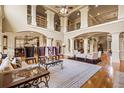 Open living space with high ceilings, large windows, and decorative columns perfect for entertaining at 179 Worthington Way, Jonesboro, GA 30236