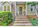 Close-up of the front entrance with brick steps, decorative wreath, and well-maintained landscaping at 248 Riverview Trl, Roswell, GA 30075