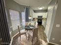 Bright kitchen and breakfast nook with white cabinets and stainless steel appliances at 2572 Laurel Cir, Atlanta, GA 30311