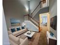 Inviting living room with staircase, neutral colors, stylish decor, and abundant natural light at 2572 Laurel Cir, Atlanta, GA 30311