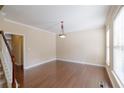 Bright living room features hardwood floors, crown molding, and a light fixture at 4400 Village Field Pl, Suwanee, GA 30024