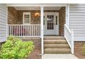 Inviting front porch with cedar shingles and white trim detail at 7533 Mason Falls Dr, Winston, GA 30187