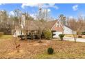 A single Gathering home with a brick facade, a two-car garage, and a quaint front porch at 105 Hunters, Mcdonough, GA 30253