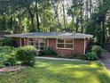 Beautiful brick home with mature landscaping, offering a peaceful and inviting curb appeal at 1461 Alverado Way, Decatur, GA 30032