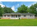 Charming single-story home with inviting front porch and well-maintained lawn at 1810 King Mill Rd, Mcdonough, GA 30252