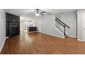Open-concept living room featuring hardwood floors, a fireplace, and a staircase at 1823 Devon Dr # 1823, Atlanta, GA 30311
