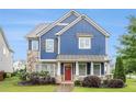 Inviting two-story home boasts blue siding and stone accents, enhanced by a beautifully landscaped front yard at 1946 Jeffery Nw Rd, Atlanta, GA 30318
