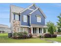 Two-story home featuring blue siding, stone accents, and well-maintained landscaping in a suburban neighborhood at 1946 Jeffery Nw Rd, Atlanta, GA 30318