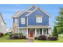 Charming two-story home featuring stone accents, a well-manicured lawn, and a red front door at 1946 Jeffery Nw Rd, Atlanta, GA 30318