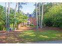 Traditional brick home with mature trees, offering a serene and private setting at 361 Sarah Ln, Lawrenceville, GA 30046