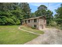 Spacious home featuring a two-car garage and a long, paved driveway at 530 Village Green Sw Ct, Lilburn, GA 30047