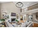 Open living room features soaring ceilings, custom built-ins, stone fireplace and hardwood flooring at 1235 Grand View Se Dr, Smyrna, GA 30126