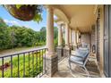 Inviting front porch with stone pillars, iron railing, and comfortable seating, perfect for relaxing outdoors at 1235 Grand View Se Dr, Smyrna, GA 30126