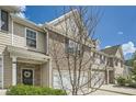 View of townhome exterior with brick and siding, front lawn, and a driveway at 3070 Fareed St, Douglasville, GA 30135