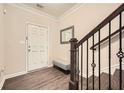 Foyer with hardwood floors, wooden staircase, and a view of the front door and mirror at 3070 Fareed St, Douglasville, GA 30135