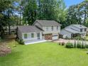View of well-maintained two-story home, showcasing a lush lawn and mature trees enhancing the property's curb appeal at 3227 Fescue Cir, Lawrenceville, GA 30044