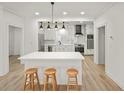 Open kitchen features an island with seating, modern appliances, and stylish pendant lighting above the island at 3649 Peachtree Ne Rd # 305, Atlanta, GA 30319
