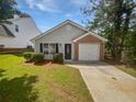 Charming single-story home with gray siding, brick accent, and well-maintained front lawn at 6795 Browns Mill Walk, Lithonia, GA 30038