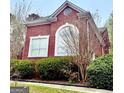 Charming brick home featuring large windows and lush landscaping at 1090 Crown River Pkwy, Mcdonough, GA 30252