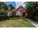 Attractive brick home with lush landscaping and a welcoming front entrance at 1090 Crown River Pkwy, Mcdonough, GA 30252