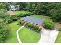A well-manicured lawn complements this charming brick home with a newer roof at 388 Talcott Nw Cir, Marietta, GA 30064