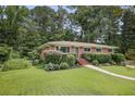 Beautiful one-story brick home with well-manicured lawn, mature trees, and inviting entrance at 388 Talcott Nw Cir, Marietta, GA 30064
